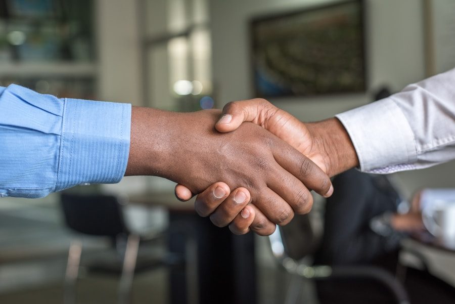 Two people shaking hands after an approval